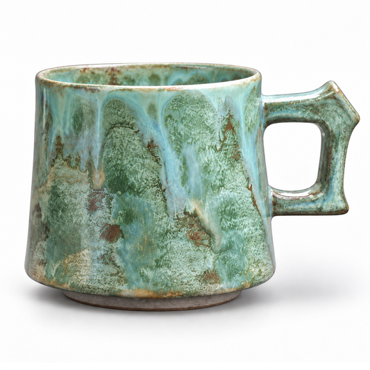 Green ceramic mug, white studio background, aligned with the blue and pink mugs